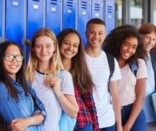 High school students standing in a row in front of lockers